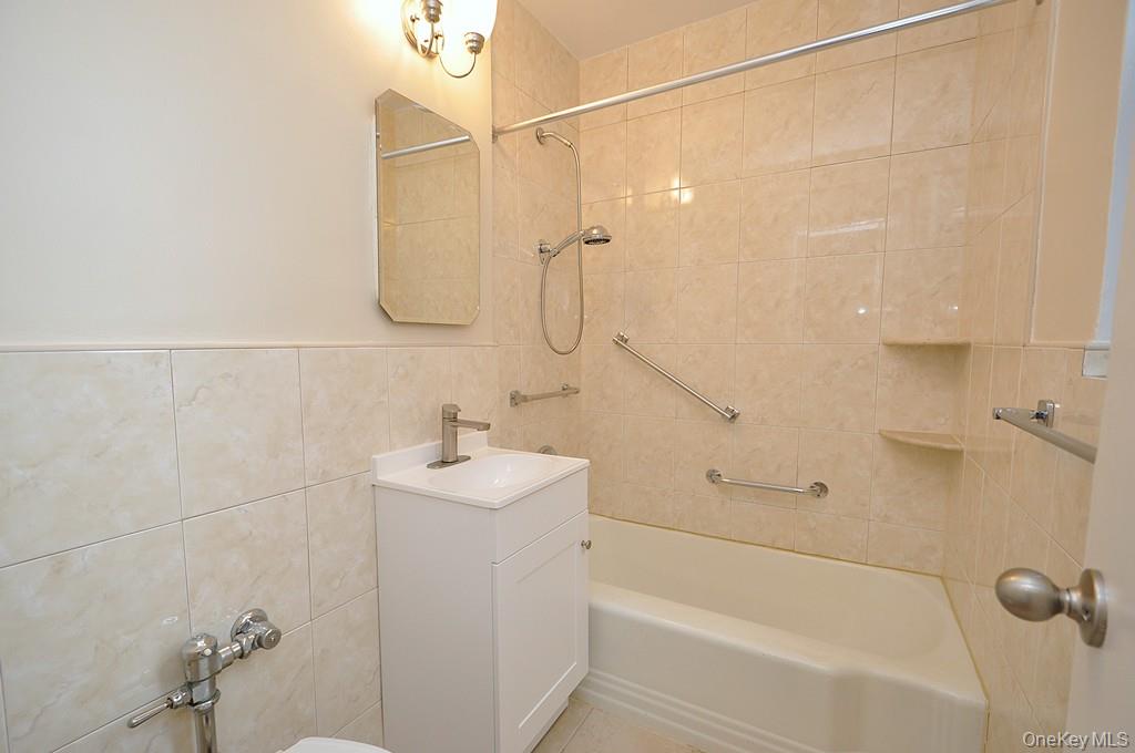 142 Garth Road, Unit 4A Scarsdale, NY 10583 - Photo 20 of 44 a bathroom with a shower a sink and a mirror