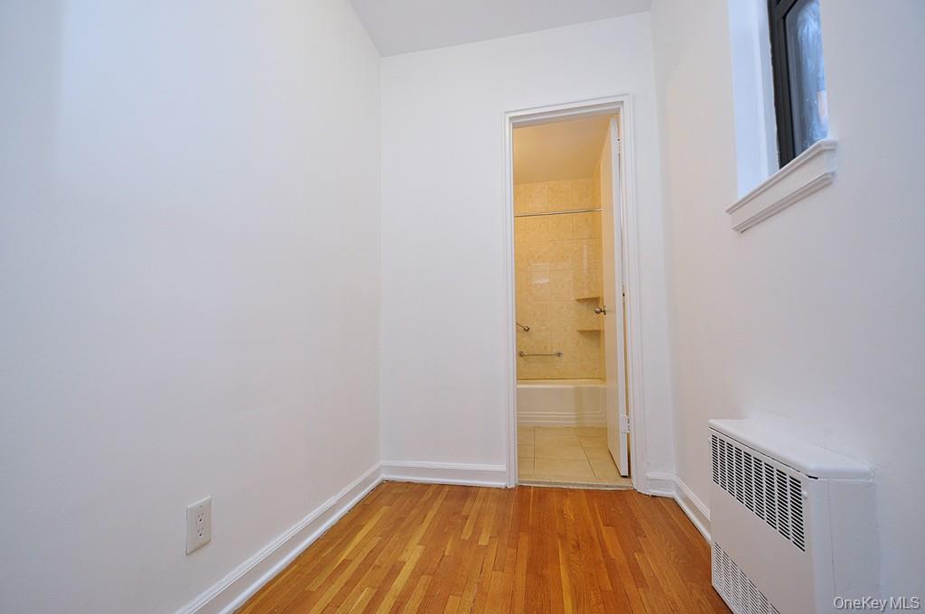 142 Garth Road, Unit 4A Scarsdale, NY 10583 - Photo 22 of 44 a view of a room with wooden floor and a window