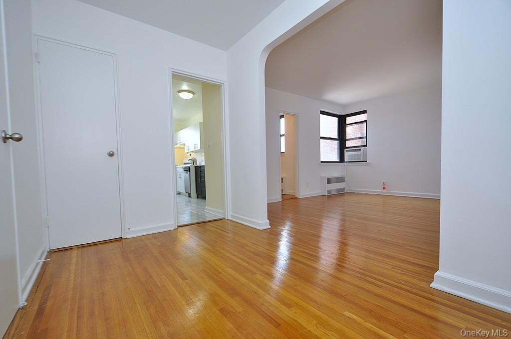 142 Garth Road, Unit 4A Scarsdale, NY 10583 - Photo 27 of 44 wooden floor in an empty room with a window