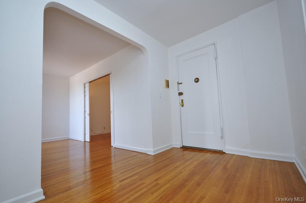 142 Garth Road, Unit 4A Scarsdale, NY 10583 - Photo 28 of 44 a view of an empty room with wooden floor