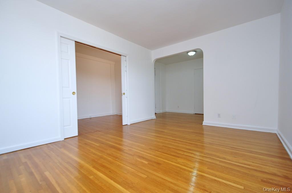 142 Garth Road, Unit 4A Scarsdale, NY 10583 - Photo 6 of 44 a view of an empty room with wooden floor and closet