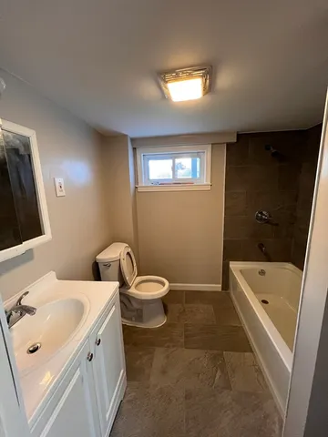 a bathroom with a sink a toilet and bathtub