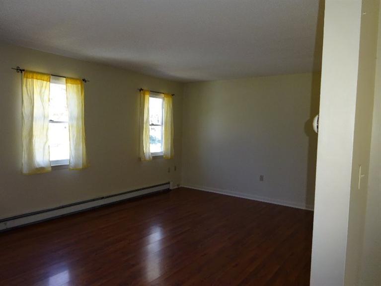 2 Lord Hayford Road Buzzards Bay, MA 02532 - Photo 5 of 16 an empty room with wooden floor and windows
