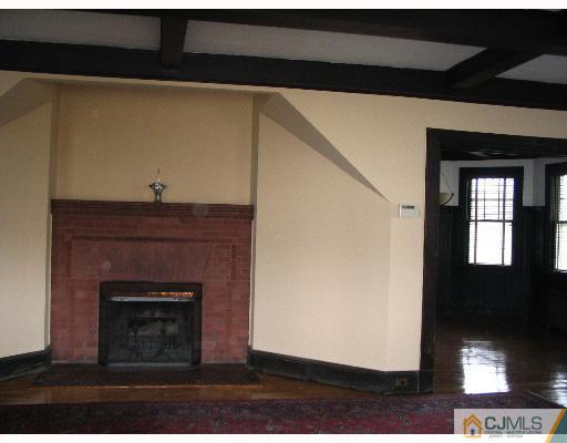 176 Washington Road Sayreville, NJ 08872 - Photo 3 of 8 a living room with a fireplace
