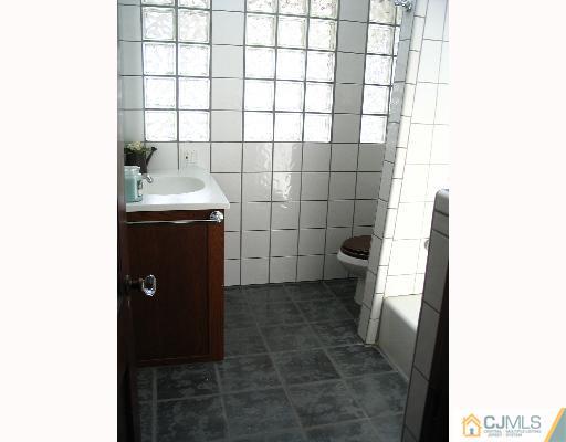 176 Washington Road Sayreville, NJ 08872 - Photo 5 of 8 a bathroom with a sink and a shower