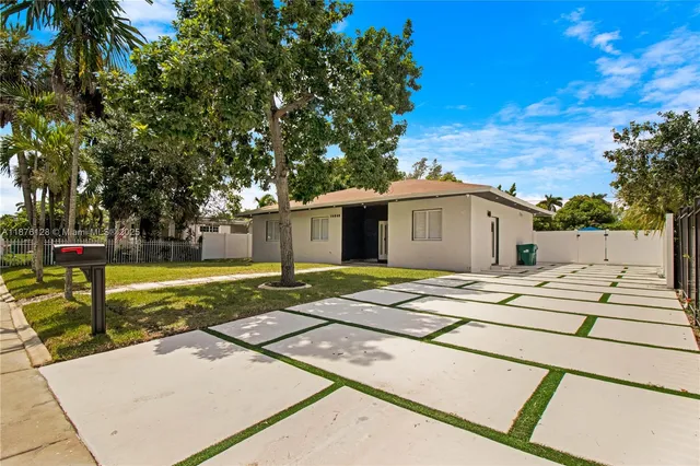 a view of a house with palm trees