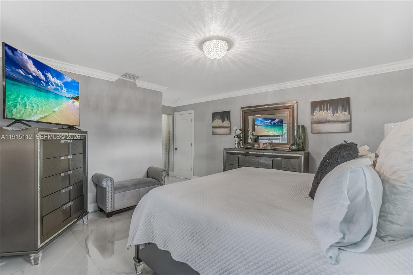 12601 Southwest 204th Street Miami, FL 33177 - Photo 12 of 40 a bedroom with a bed and a flat screen tv