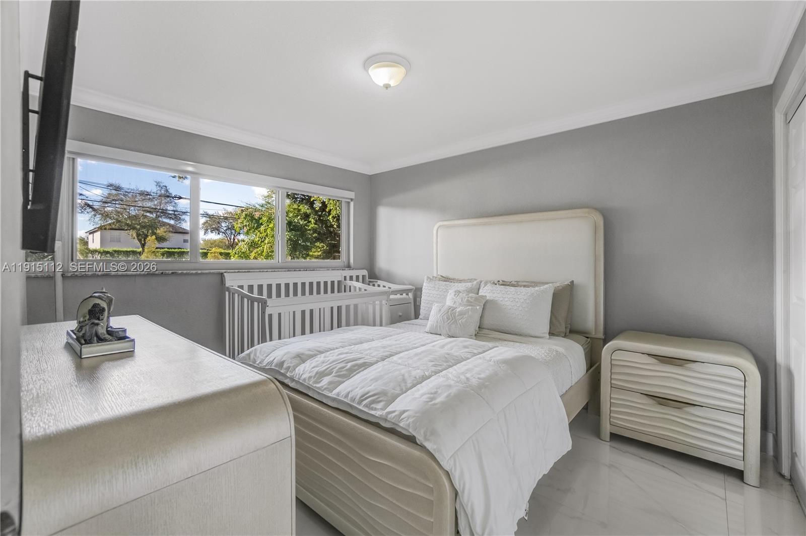 12601 Southwest 204th Street Miami, FL 33177 - Photo 15 of 40 a bedroom with a bed and a window