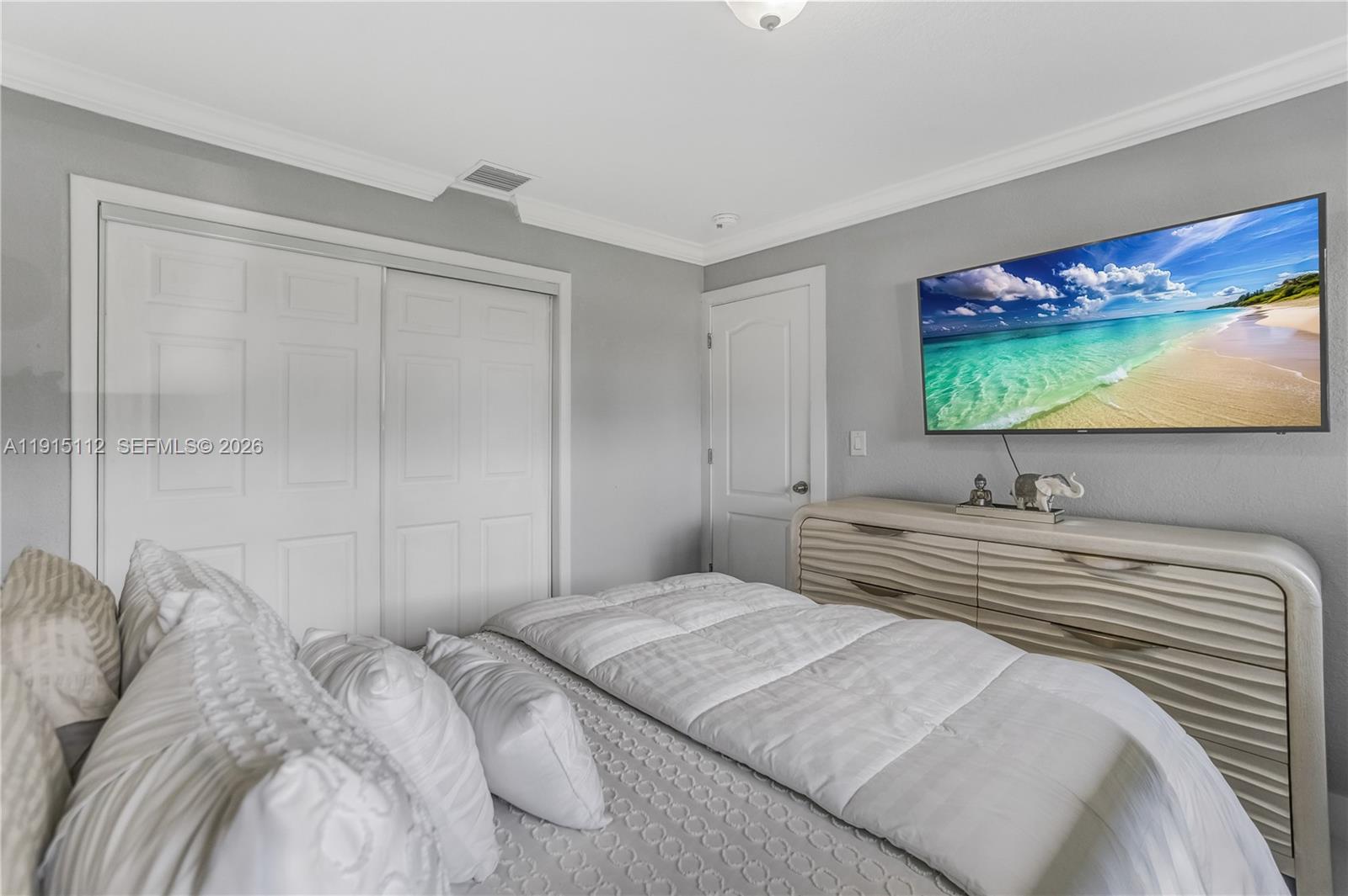 12601 Southwest 204th Street Miami, FL 33177 - Photo 16 of 40 a bedroom with a bed and a flat screen tv