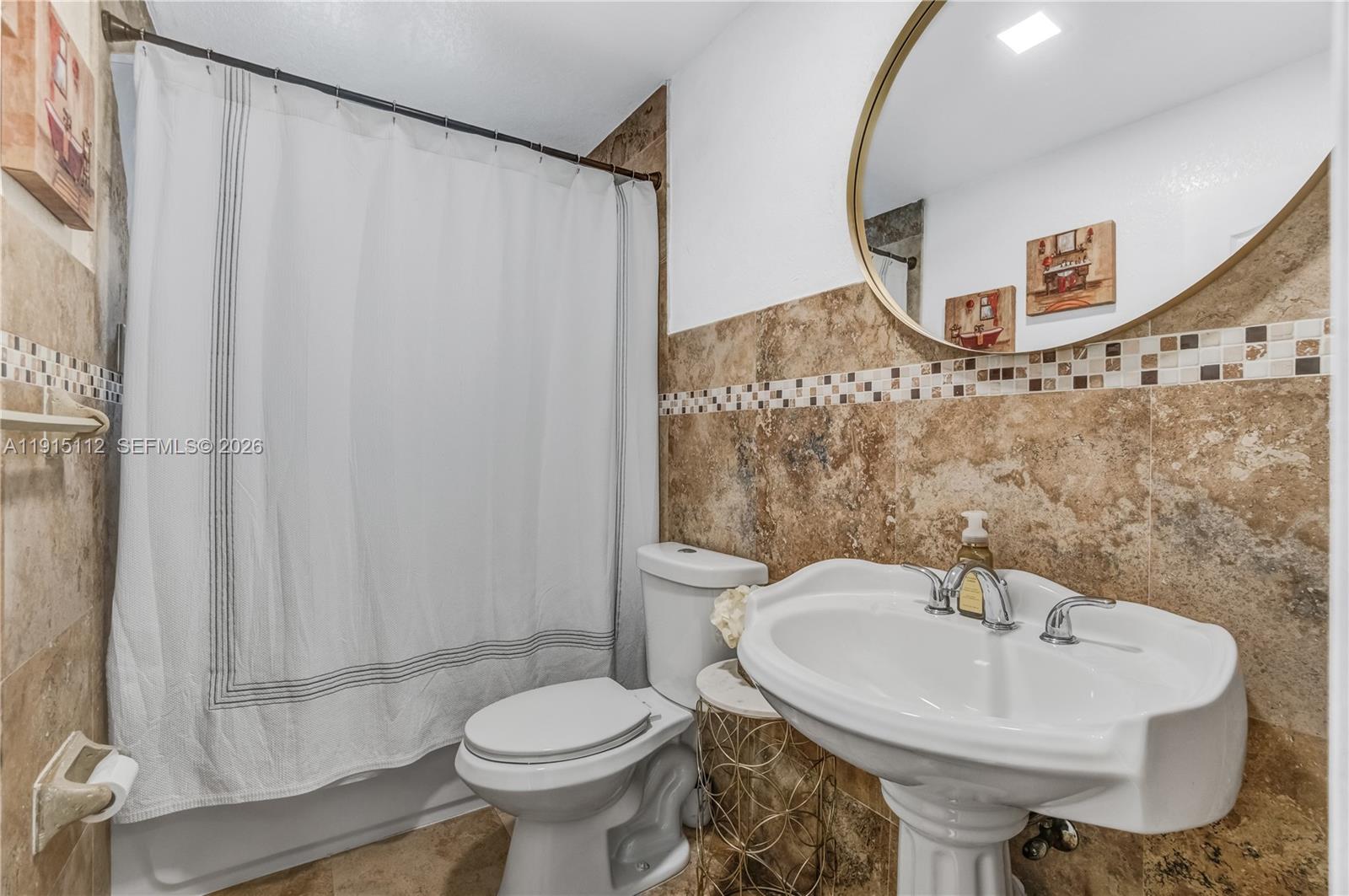 12601 Southwest 204th Street Miami, FL 33177 - Photo 17 of 40 a bathroom with a sink toilet and mirror