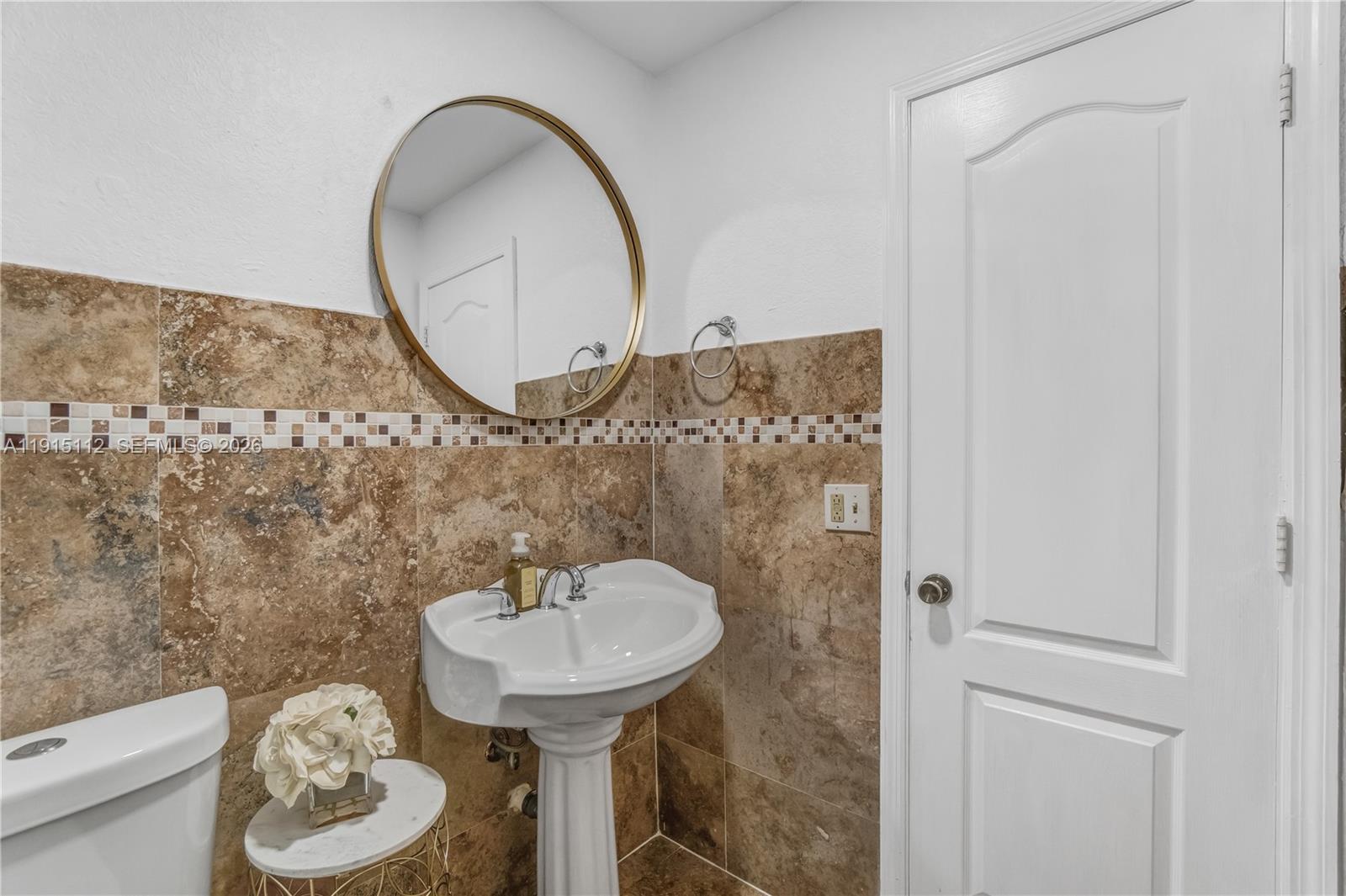 12601 Southwest 204th Street Miami, FL 33177 - Photo 18 of 40 a bathroom with a sink and a mirror