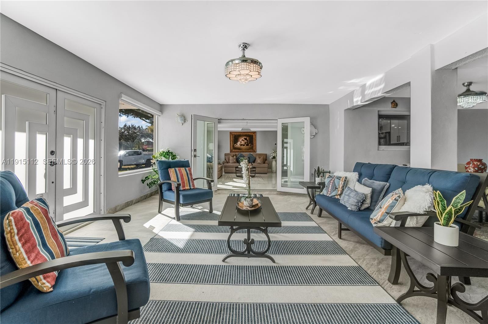 12601 Southwest 204th Street Miami, FL 33177 - Photo 21 of 40 a living room with furniture a fireplace and a table