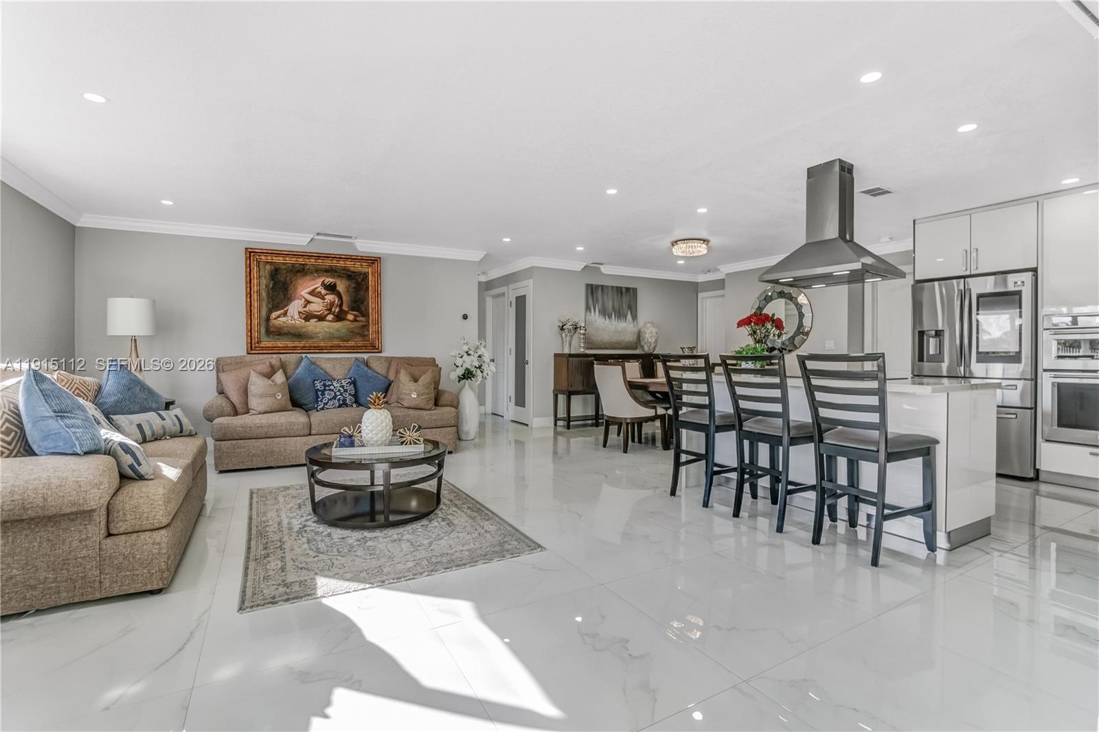 12601 Southwest 204th Street Miami, FL 33177 - Photo 24 of 40 a living room with furniture and kitchen view