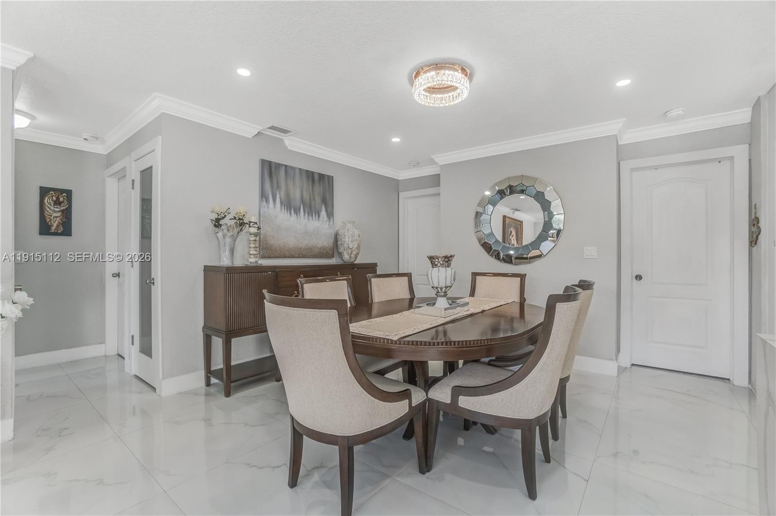 12601 Southwest 204th Street Miami, FL 33177 - Photo 30 of 40 a dining room with furniture and a clock