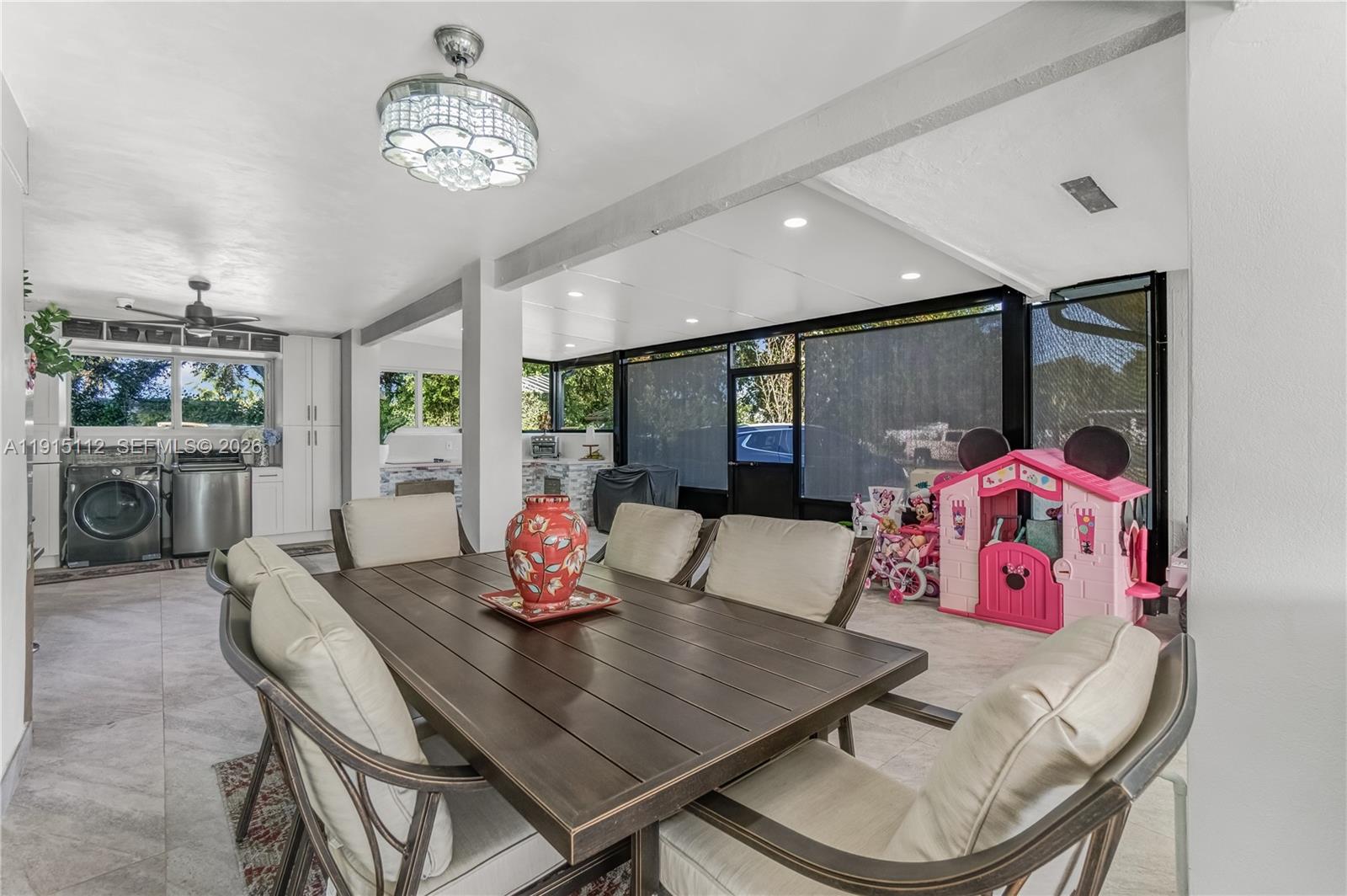12601 Southwest 204th Street Miami, FL 33177 - Photo 32 of 40 a view of a dining room with furniture a chandelier and wooden floor