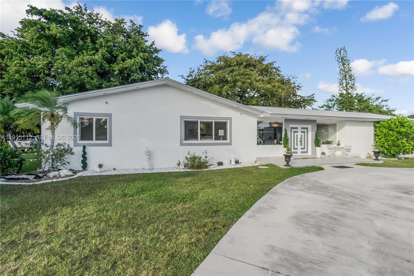 12601 Southwest 204th Street Miami, FL 33177 - Photo 36 of 40 a front view of a house with a yard