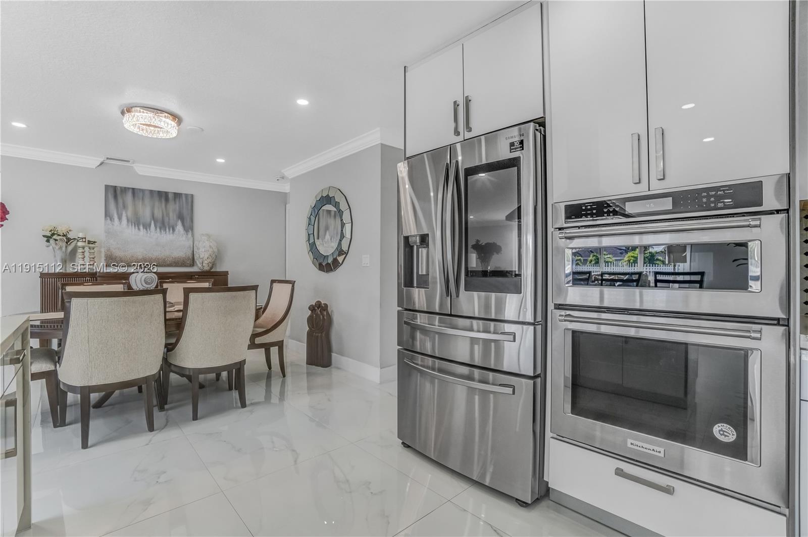 12601 Southwest 204th Street Miami, FL 33177 - Photo 7 of 40 a kitchen with stainless steel appliances a refrigerator stove top oven and cabinets