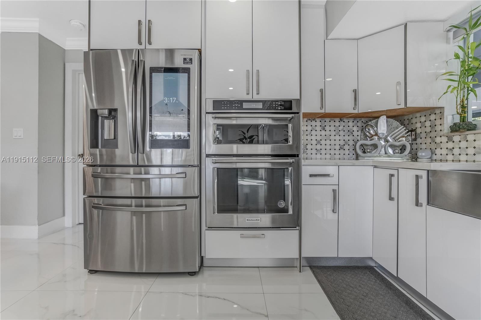 12601 Southwest 204th Street Miami, FL 33177 - Photo 9 of 40 a kitchen with stainless steel appliances granite countertop a refrigerator and a stove top oven