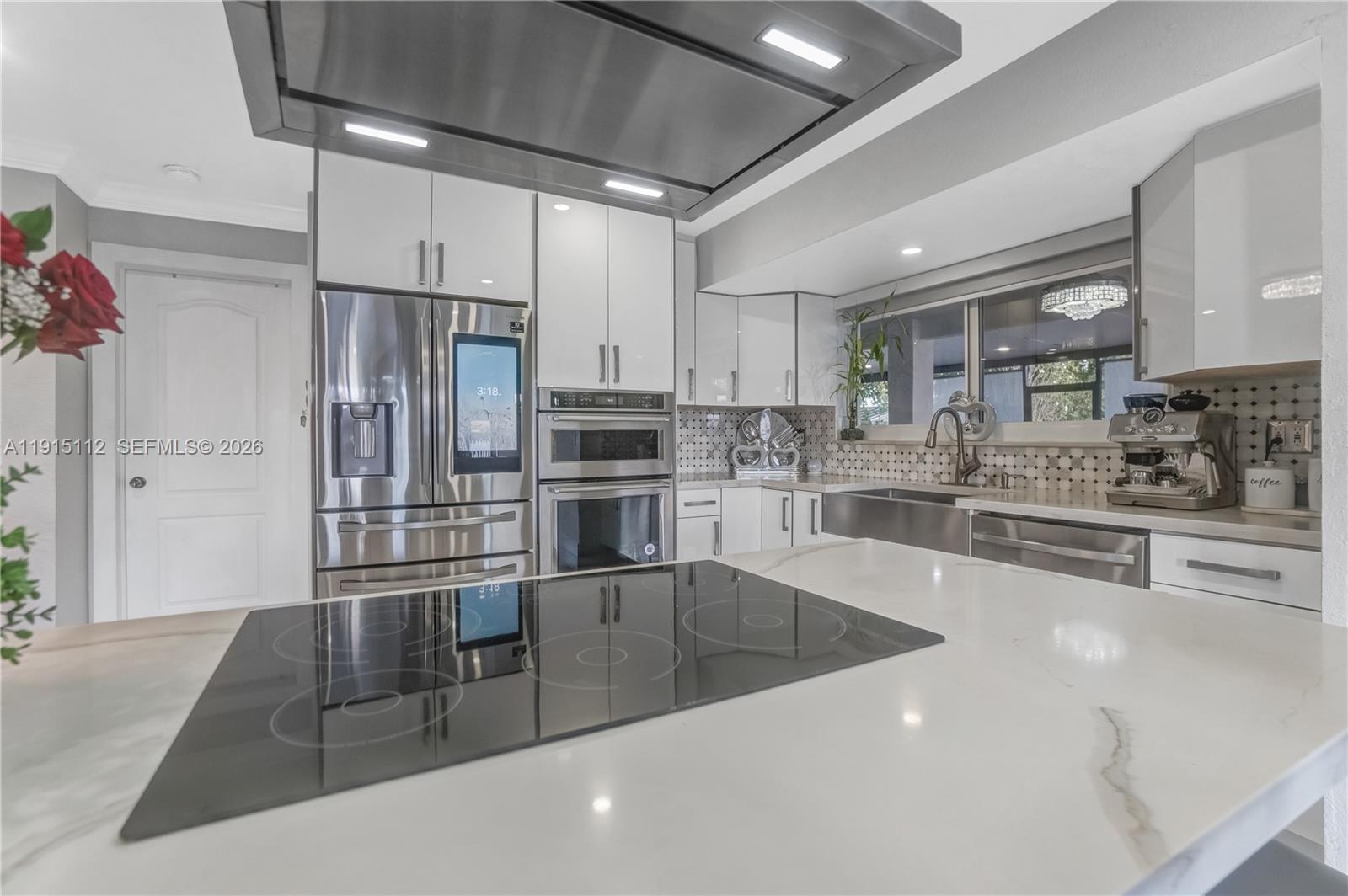 12601 Southwest 204th Street Miami, FL 33177 - Photo 10 of 40 a kitchen with stainless steel appliances a sink a stove and cabinets