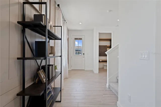 a large living room with stainless steel appliances granite countertop a couch and cabinets