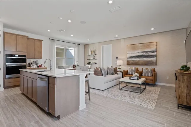 a kitchen with stainless steel appliances a refrigerator stove microwave and cabinets