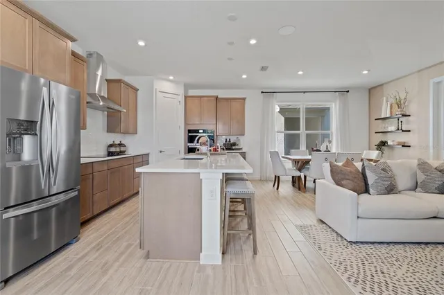 a kitchen with stainless steel appliances granite countertop a sink and a refrigerator