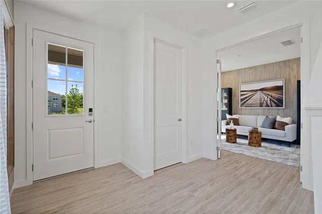 a view of a livingroom with wooden floor and furniture