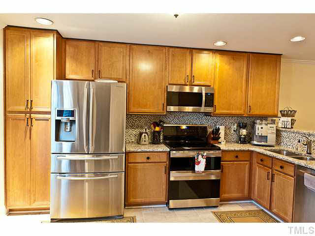 9710 Layla Avenue Raleigh, NC 27617 - Photo 11 of 25 New stove, microwave, ultra quiet dishwasher, granite counters, tile backsplash, tile floors - all replaced in 2013.