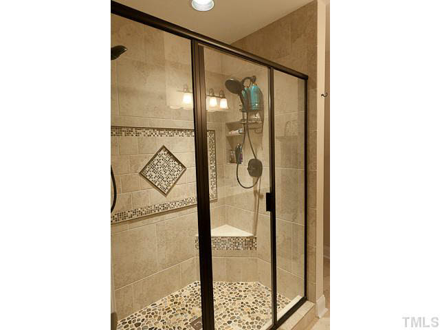 9710 Layla Avenue Raleigh, NC 27617 - Photo 19 of 25 Incredible shower. Dual shower heads, stone, tile and more. Wow!