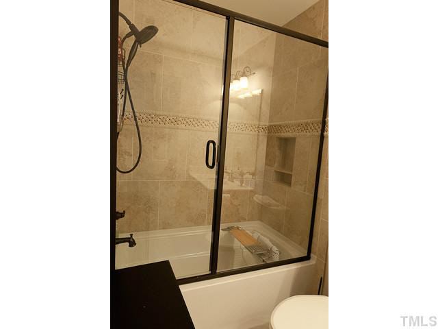 9710 Layla Avenue Raleigh, NC 27617 - Photo 22 of 25 2nd upstairs bathroom. Very custom tile surround.