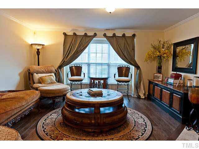 9710 Layla Avenue Raleigh, NC 27617 - Photo 4 of 25 Hardwood floors. Crown molding. Window blinds.