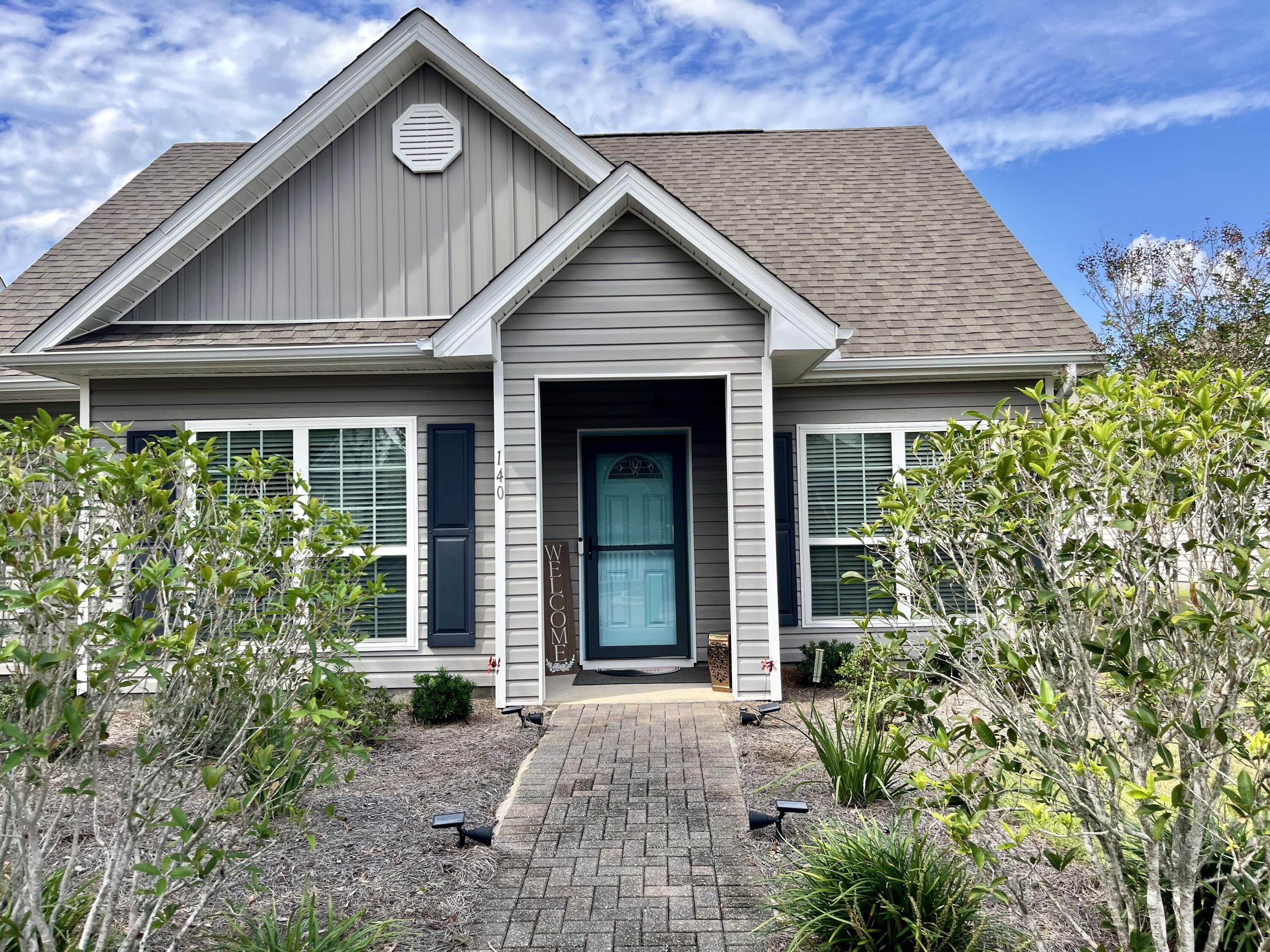 140 Nelly Street Freeport, FL 32439 - Photo 1 of 53 a front view of a house with garden