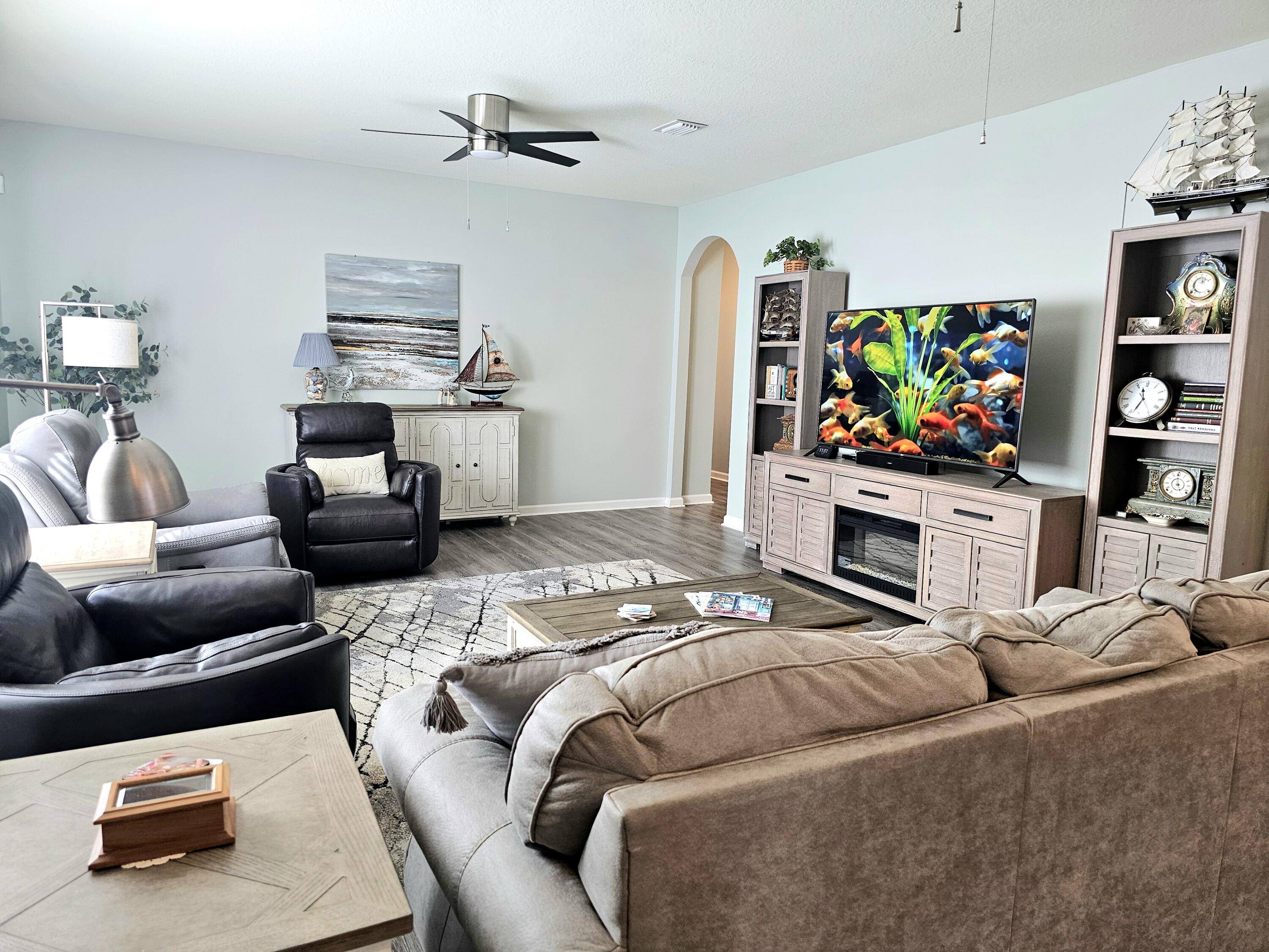 140 Nelly Street Freeport, FL 32439 - Photo 14 of 53 a bedroom with furniture and a flat screen tv