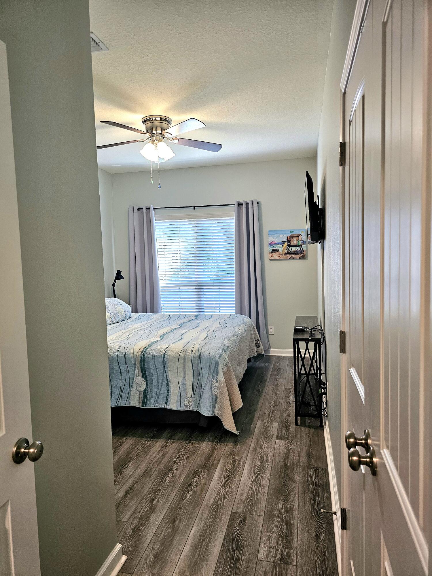 140 Nelly Street Freeport, FL 32439 - Photo 19 of 53 a spacious bedroom with a bed and wooden floor