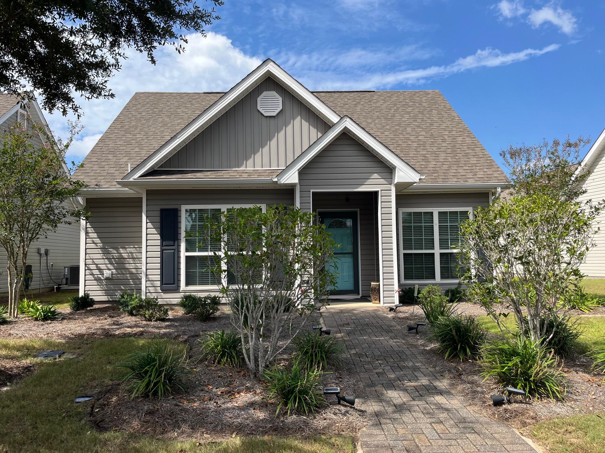 140 Nelly Street Freeport, FL 32439 - Photo 2 of 53 a front view of a house with garden