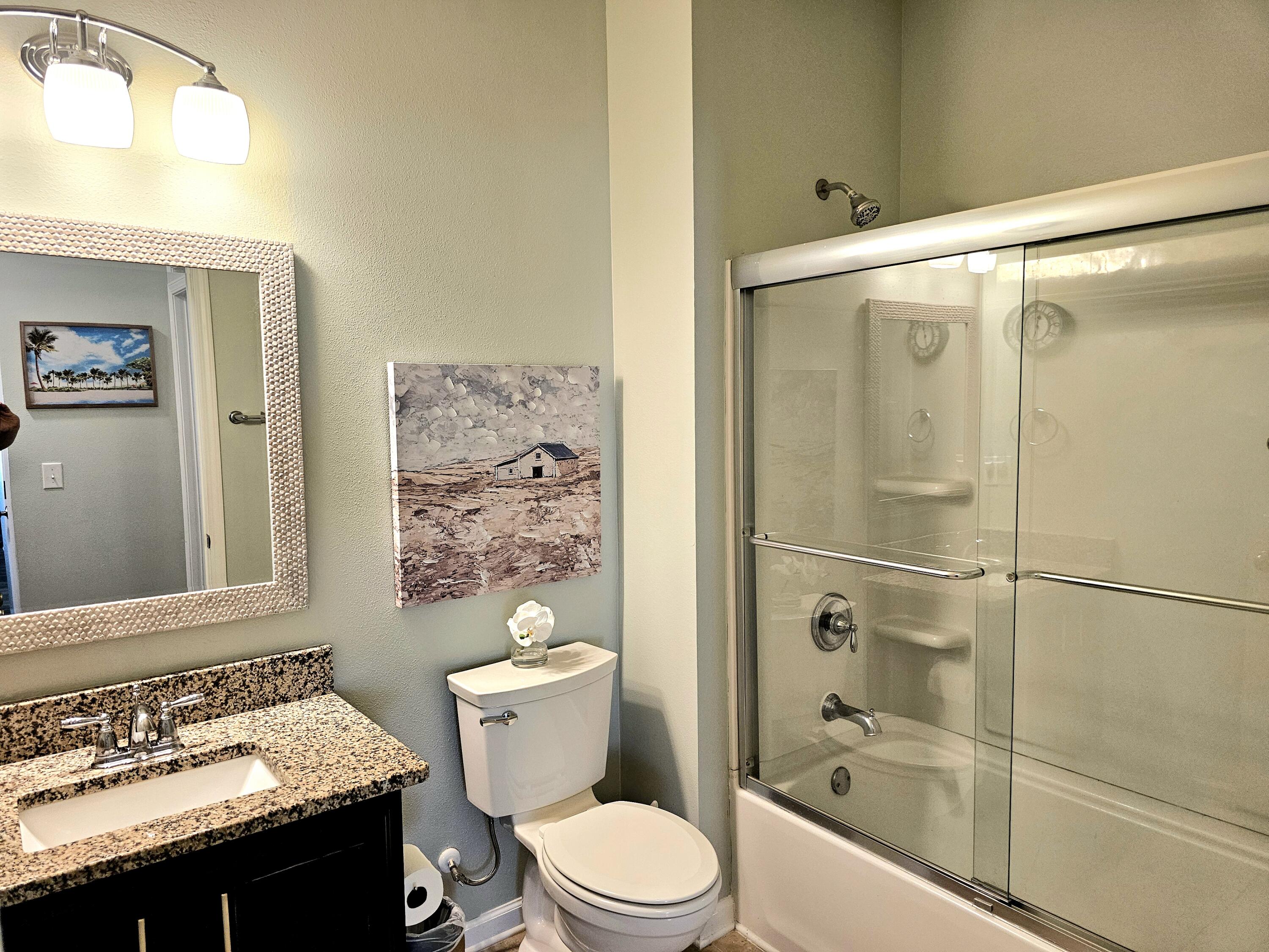 140 Nelly Street Freeport, FL 32439 - Photo 21 of 53 a bathroom with a granite countertop sink toilet and shower