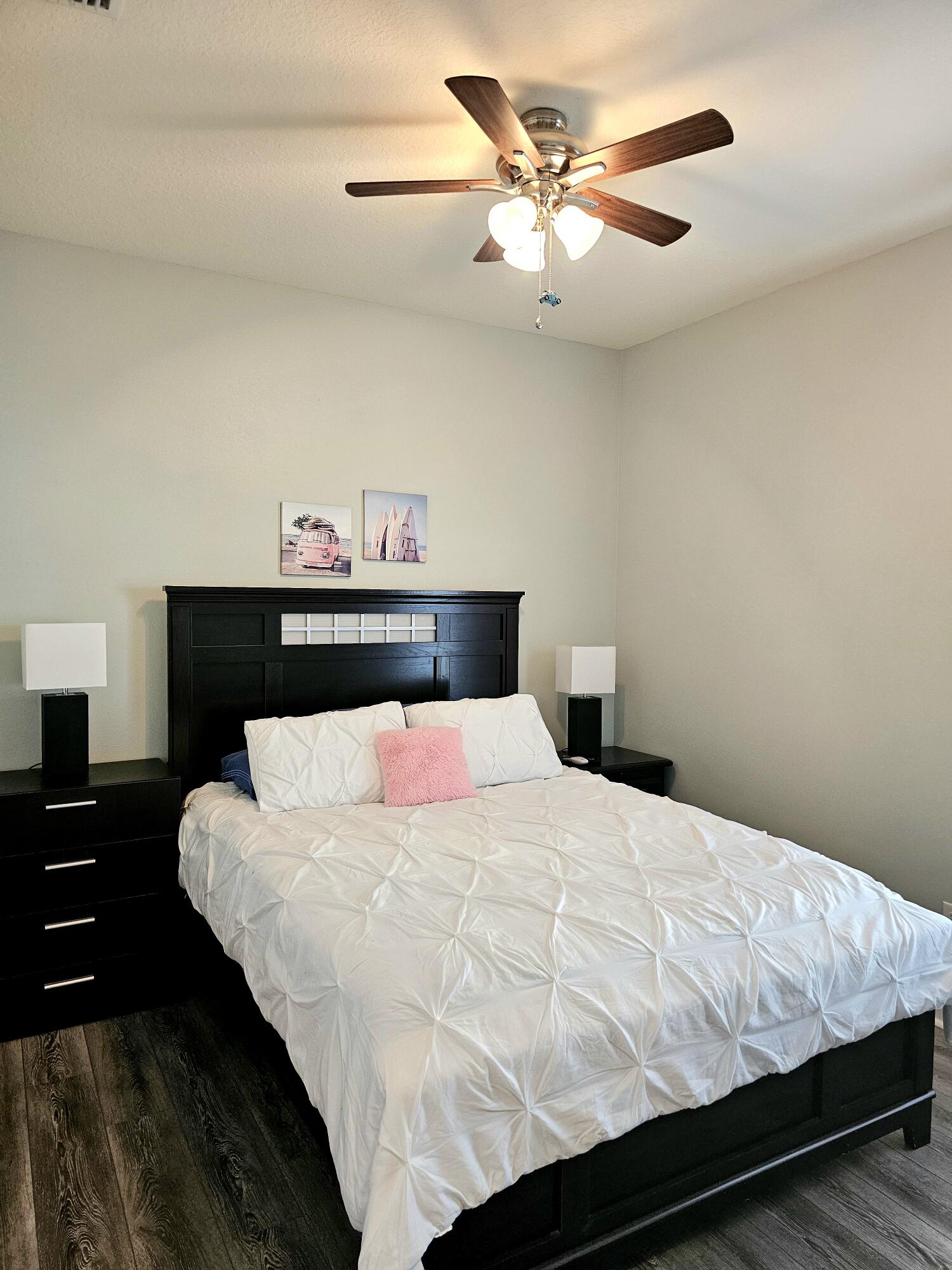 140 Nelly Street Freeport, FL 32439 - Photo 23 of 53 a bedroom with a bed and a lamp on dresser