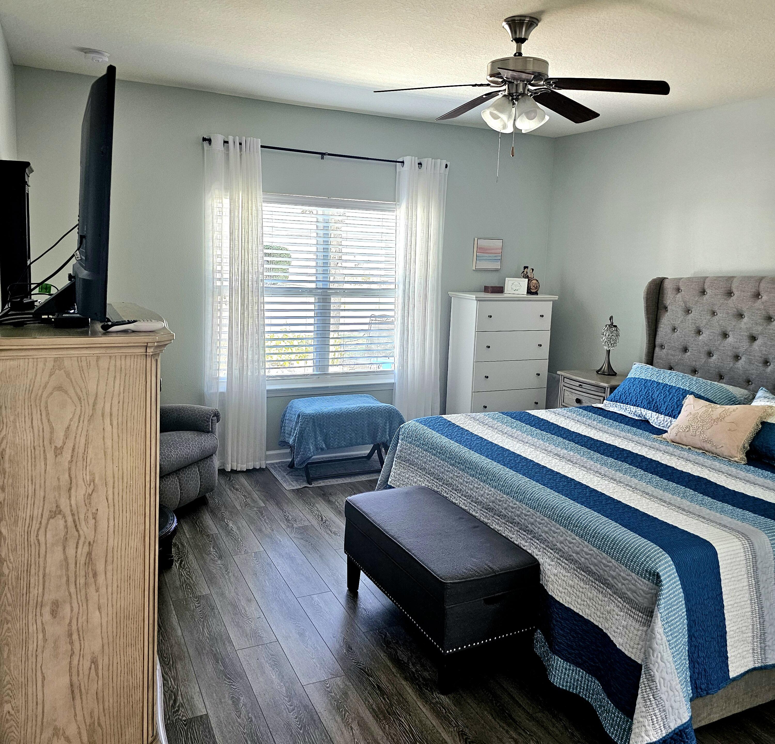 140 Nelly Street Freeport, FL 32439 - Photo 27 of 53 a bedroom with a bed furniture and a flat screen tv