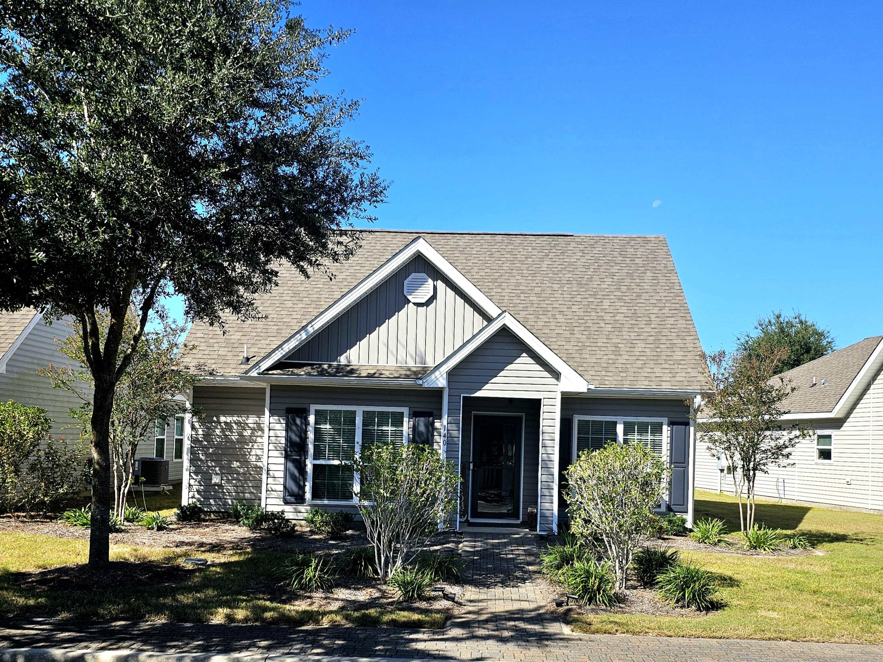 140 Nelly Street Freeport, FL 32439 - Photo 3 of 53 a front view of a house with a yard