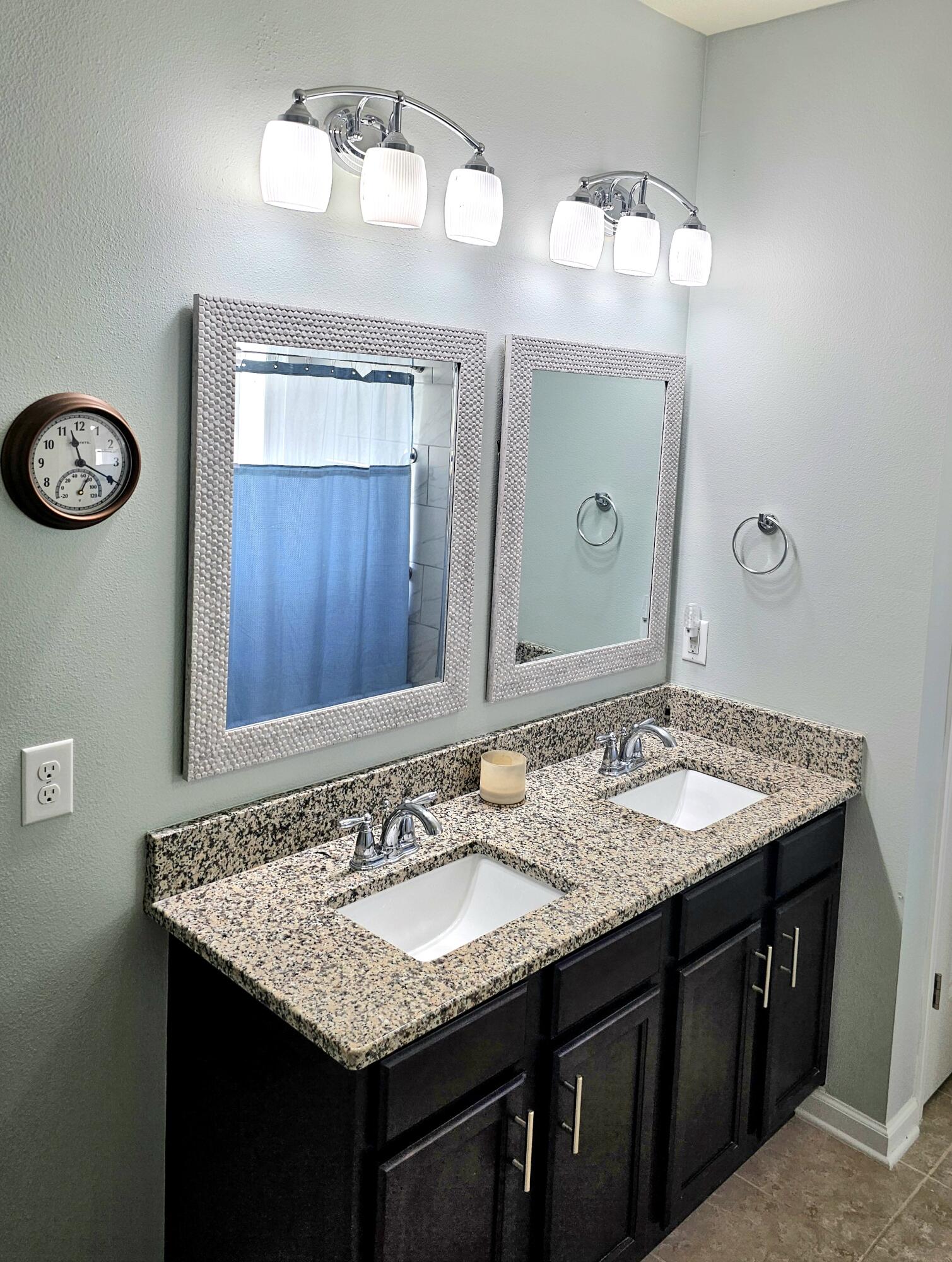 140 Nelly Street Freeport, FL 32439 - Photo 31 of 53 a bathroom with a granite countertop sink and a mirror