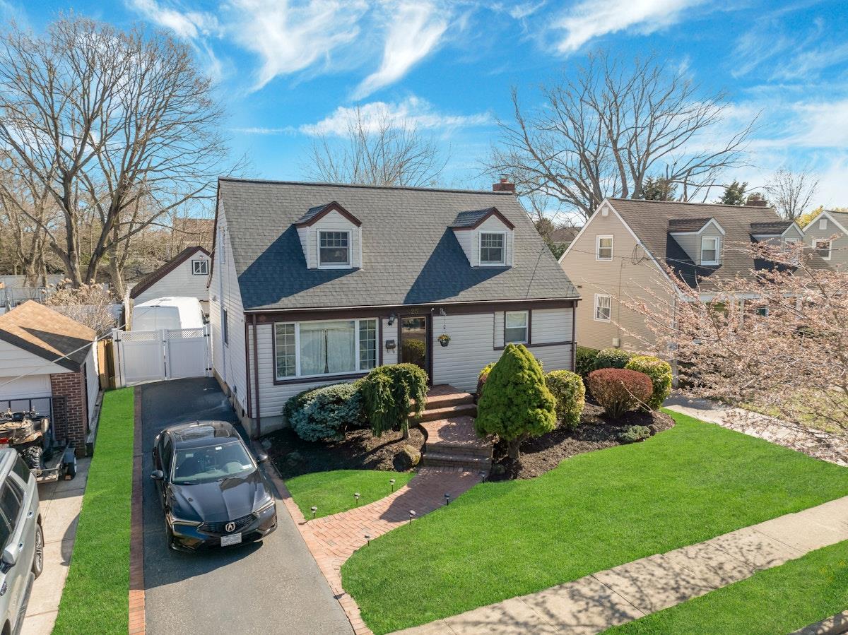 a front view of a house with garden