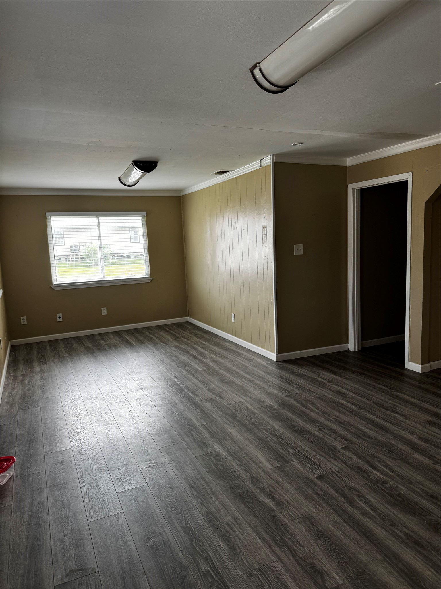 4515 7th Street Bacliff, TX 77518 - Photo 7 of 15 an empty room with wooden floor and windows