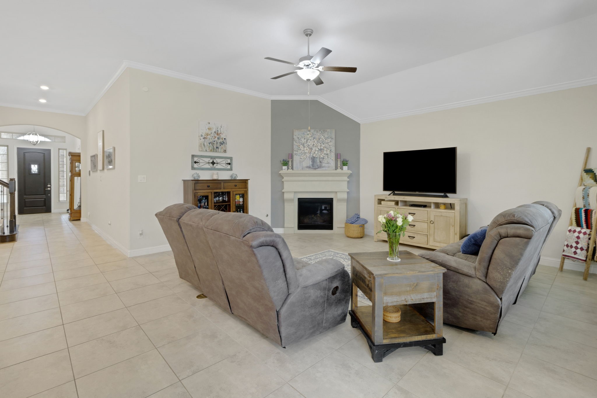 19248 Yellow Chestnut Lane New Caney, TX 77357 - Photo 10 of 42 a living room with furniture a fireplace and a flat screen tv