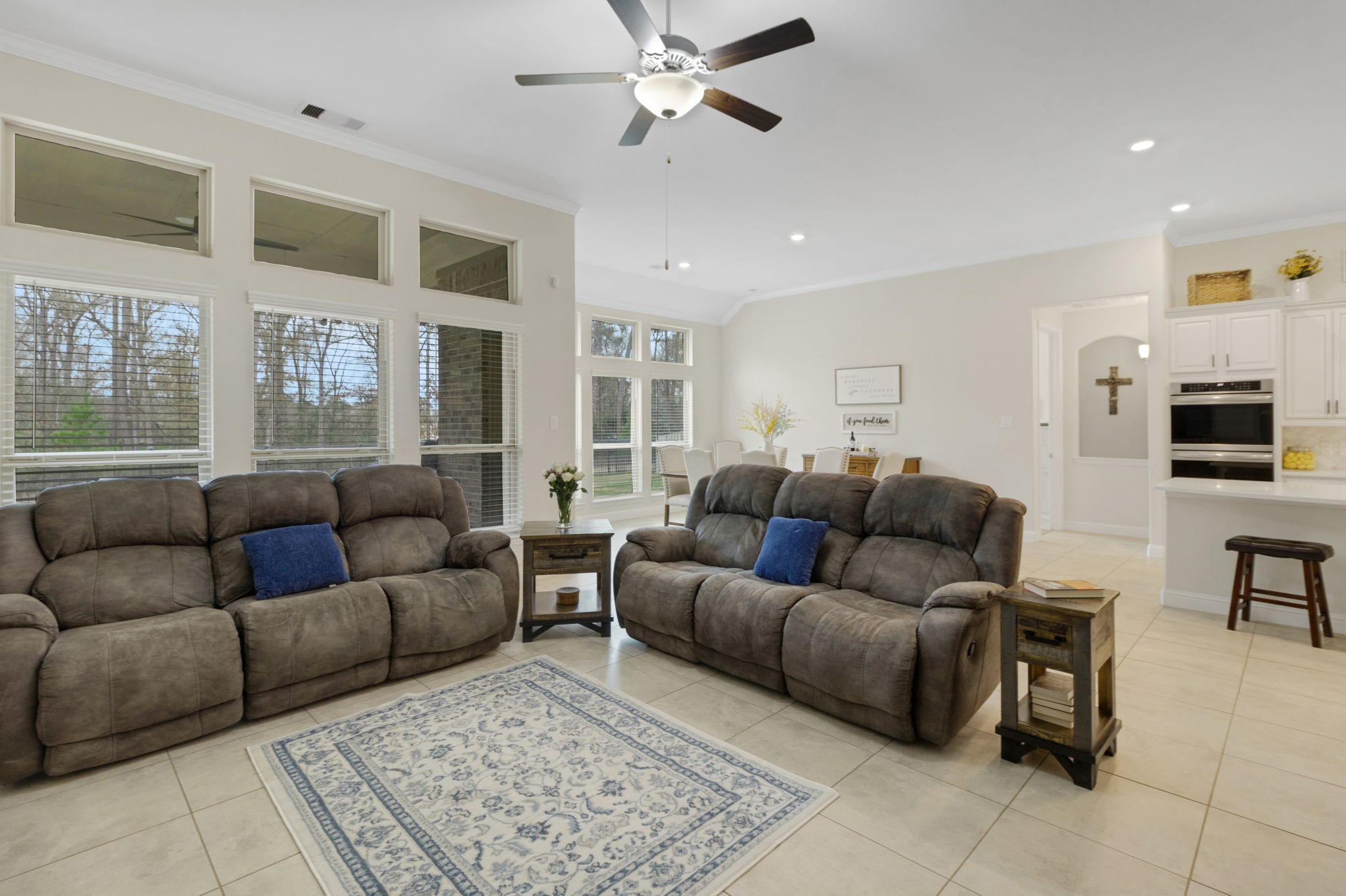 19248 Yellow Chestnut Lane New Caney, TX 77357 - Photo 11 of 42 a living room with furniture ceiling fan and a rug