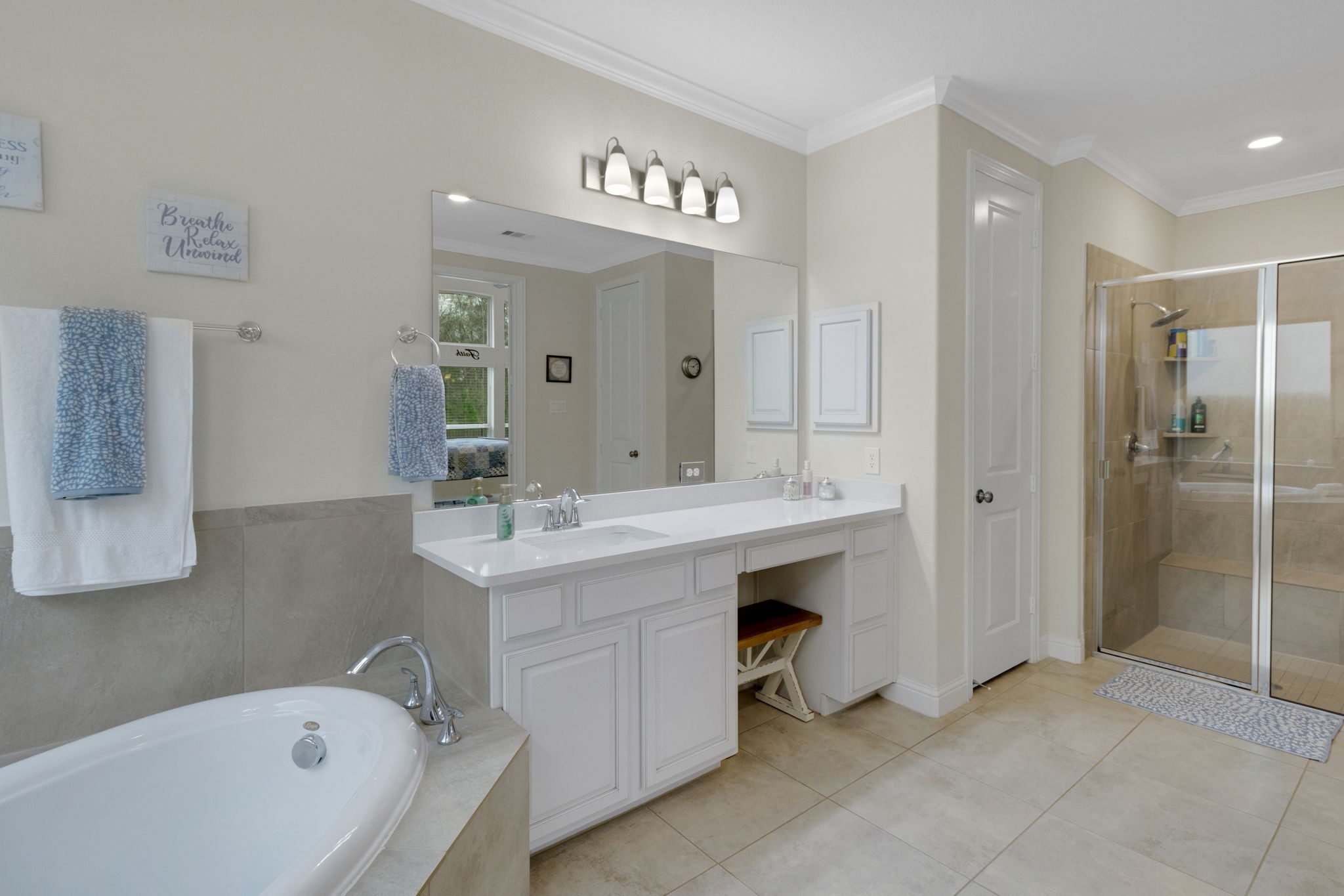 19248 Yellow Chestnut Lane New Caney, TX 77357 - Photo 15 of 42 a spacious bathroom with a bathtub sink and mirror