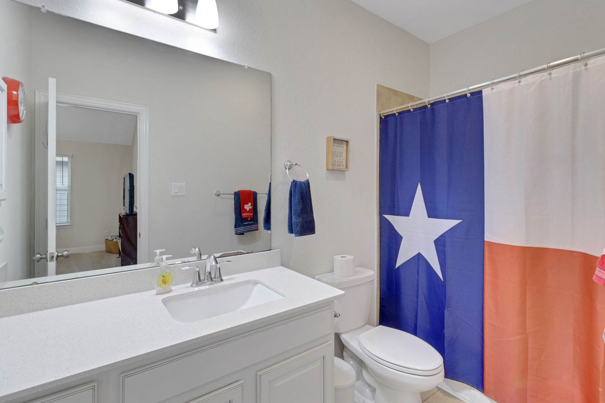 19248 Yellow Chestnut Lane New Caney, TX 77357 - Photo 24 of 42 a bathroom with a sink a toilet and shower curtain