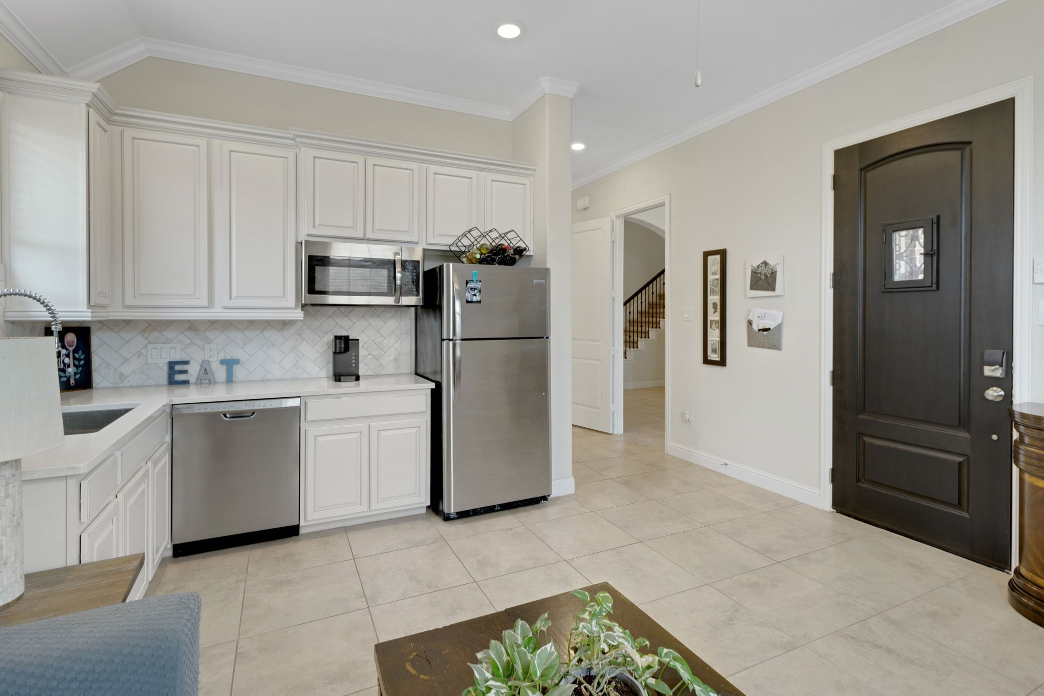 19248 Yellow Chestnut Lane New Caney, TX 77357 - Photo 30 of 42 a kitchen with a refrigerator and cabinets