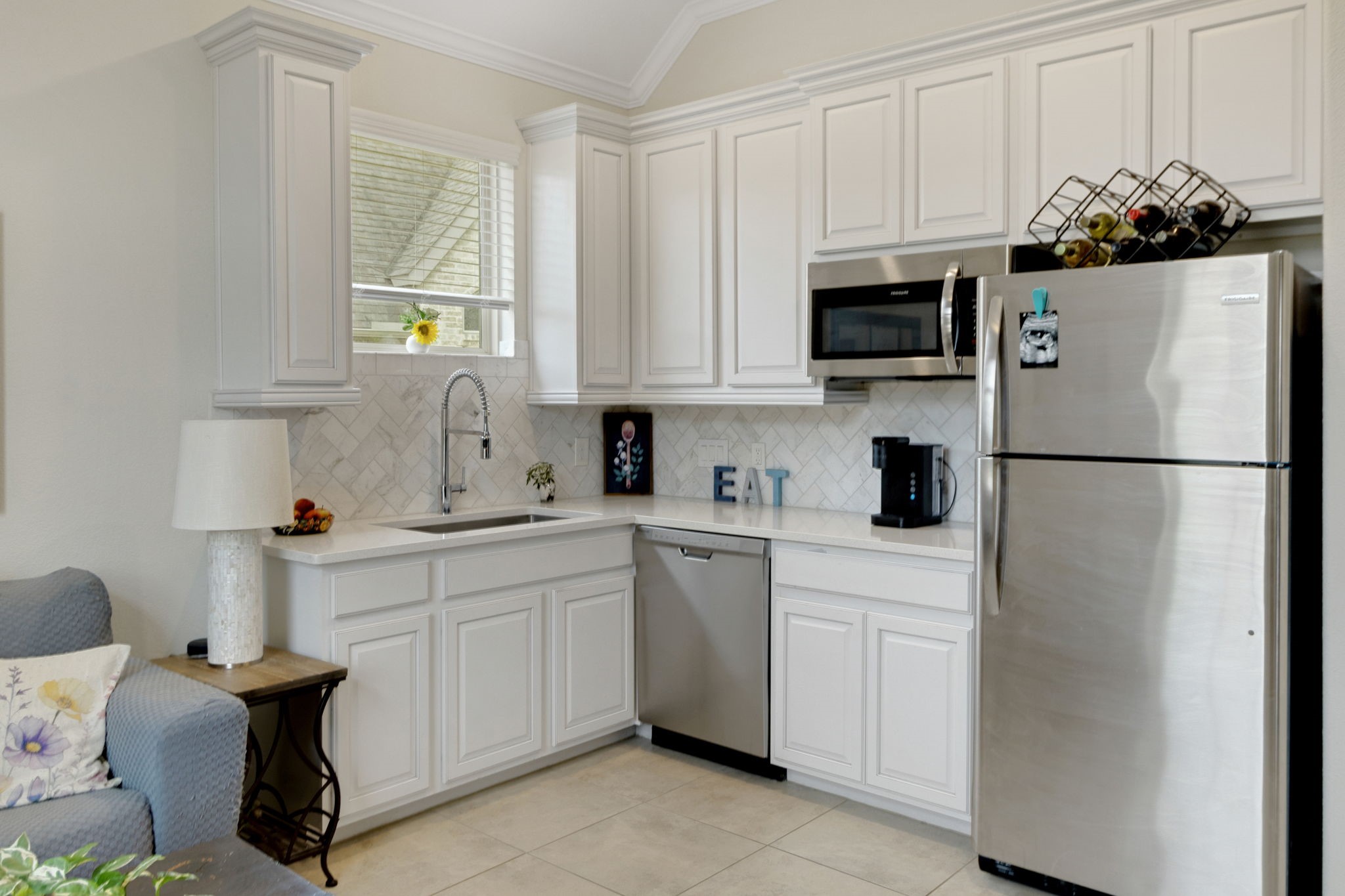 19248 Yellow Chestnut Lane New Caney, TX 77357 - Photo 31 of 42 a kitchen with white cabinets and a refrigerator