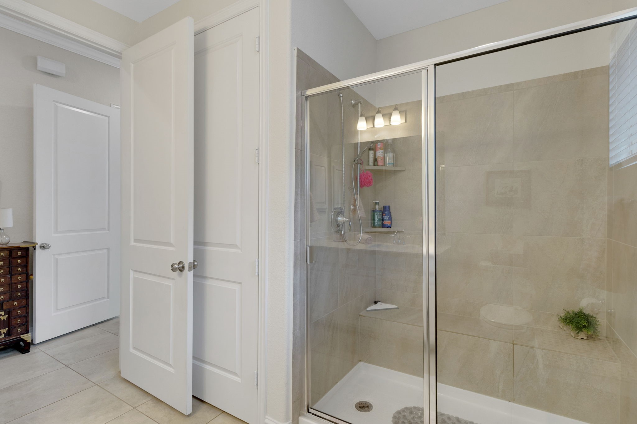 19248 Yellow Chestnut Lane New Caney, TX 77357 - Photo 33 of 42 a bathroom with a glass shower door and a sink