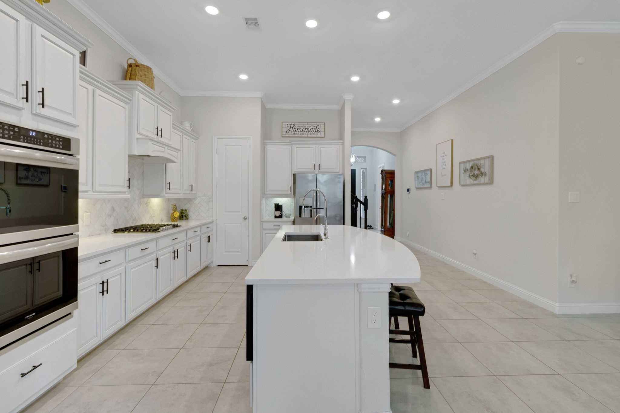 19248 Yellow Chestnut Lane New Caney, TX 77357 - Photo 4 of 42 a large white kitchen with cabinets